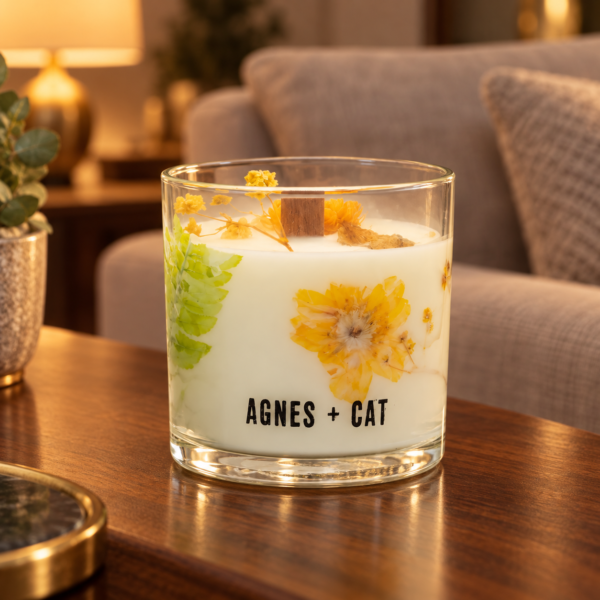 Agnes + Cat Botanical Sojawachskerze Rydal Oudh mit Trockenblüten im Glas auf einem Holztisch im Wohnzimmer